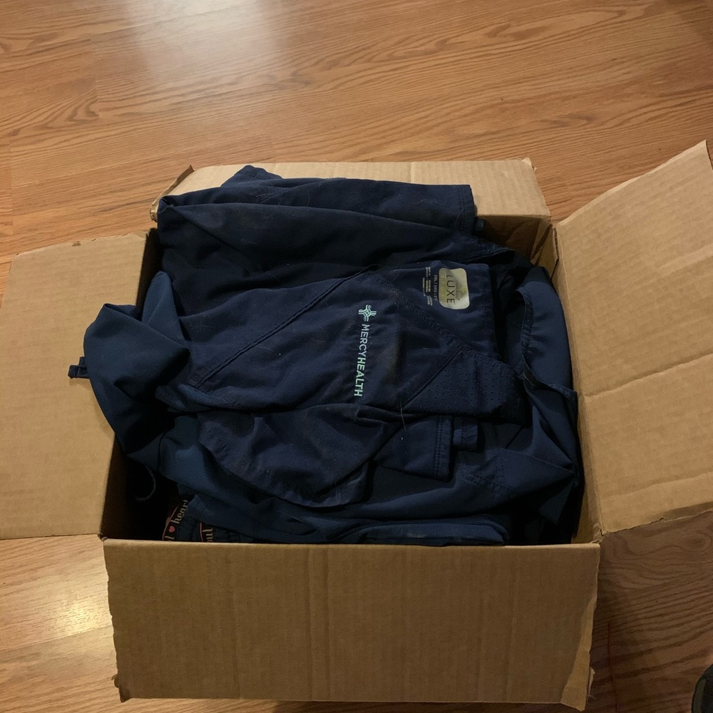 box of Mercy scrubs